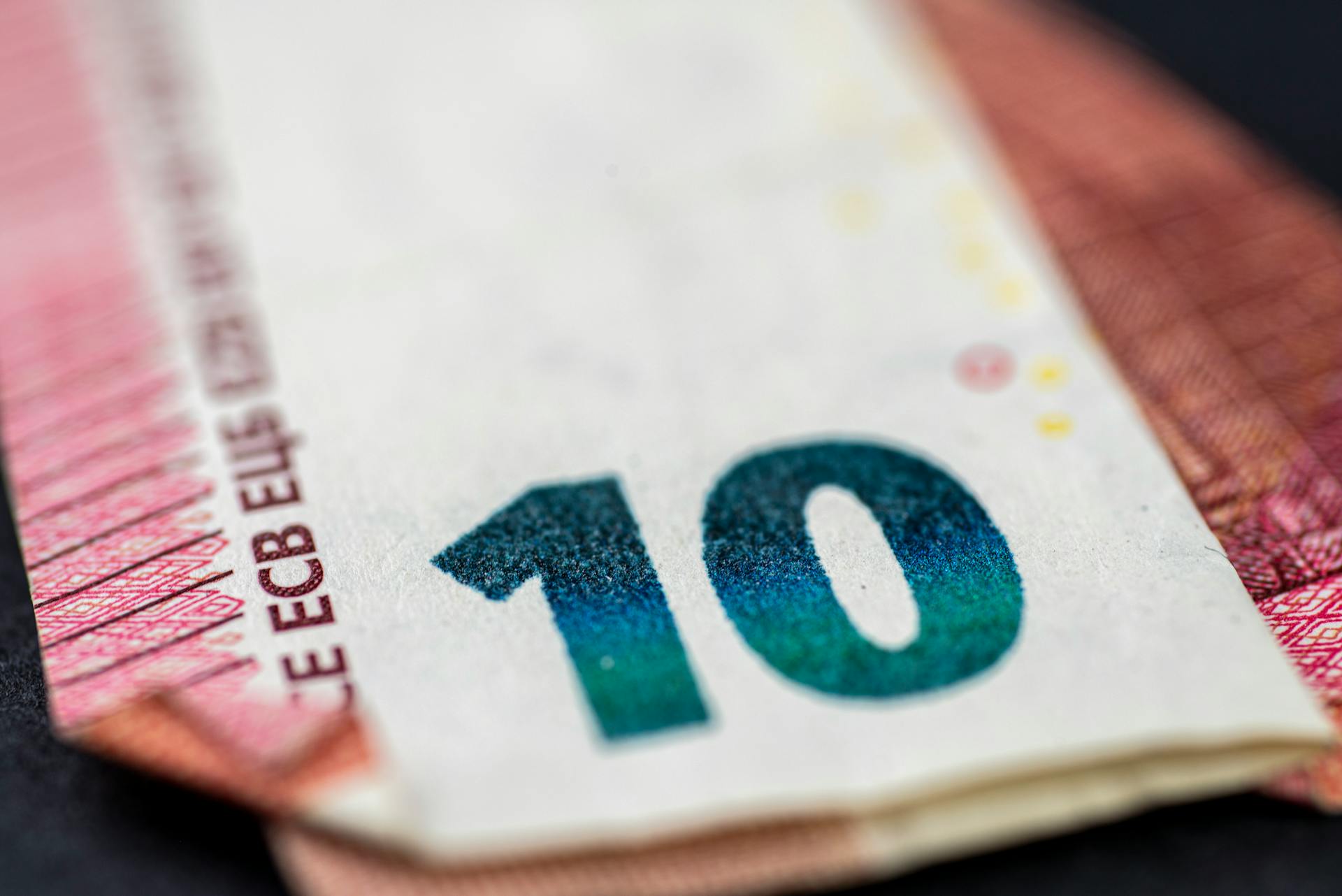 Detailed close-up of a ten euro banknote highlighting currency design and texture.