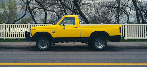 Free Yellow Truck Parked on the Road Stock Photo