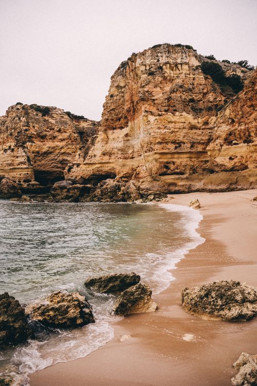 Free Stunning rocky coastline in Algarve, Faro District at the beach. Stock Photo