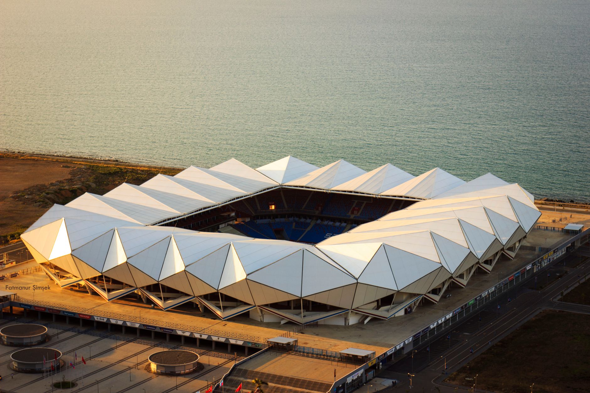 Aerial view of a modern football stadium by the sea in Trabzon, Türkiye.
