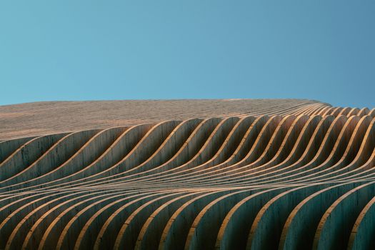 Curved patterns in modern architectural design against a clear blue sky in Athens, Greece.