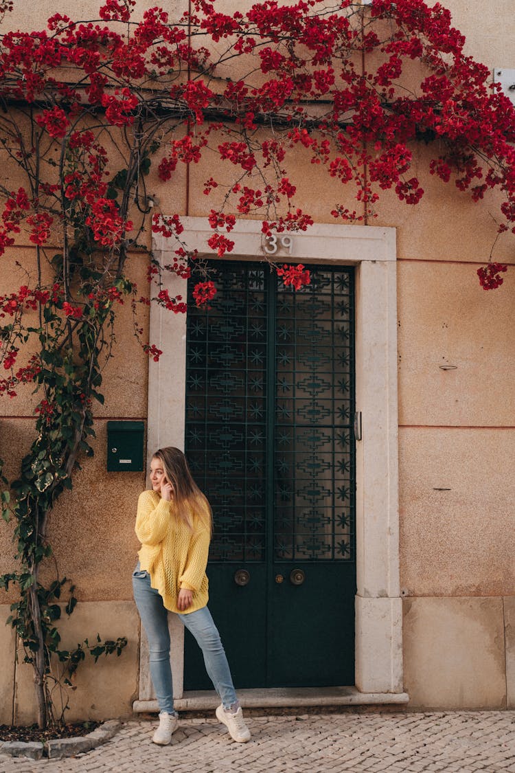 A Woman Standing In Front Of A Door