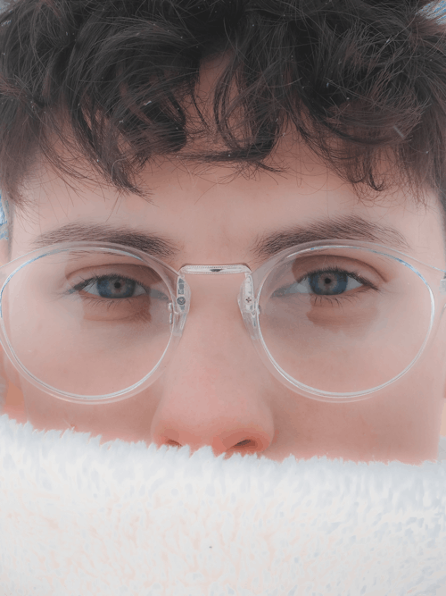 Close Up Photo of a Person Wearing Eyeglasses