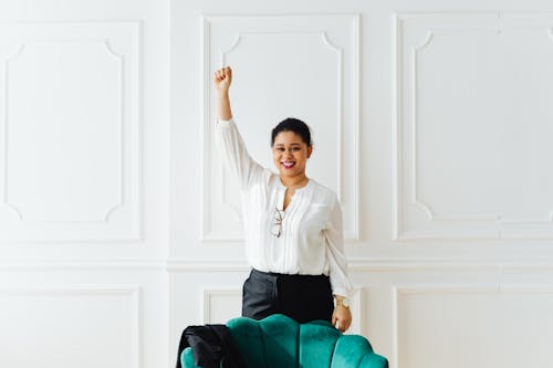 A Woman Smiling and Raising her Hand