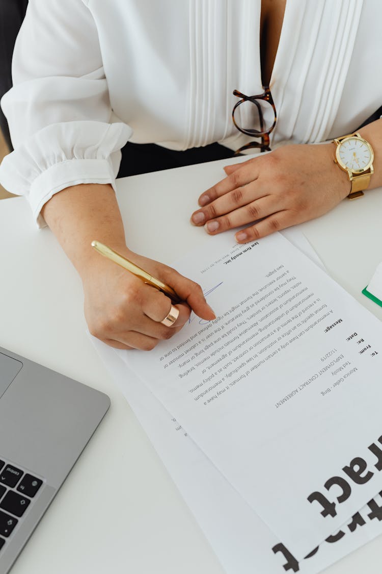 A Person Signing The Contract