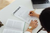 Person Writing on White Paper