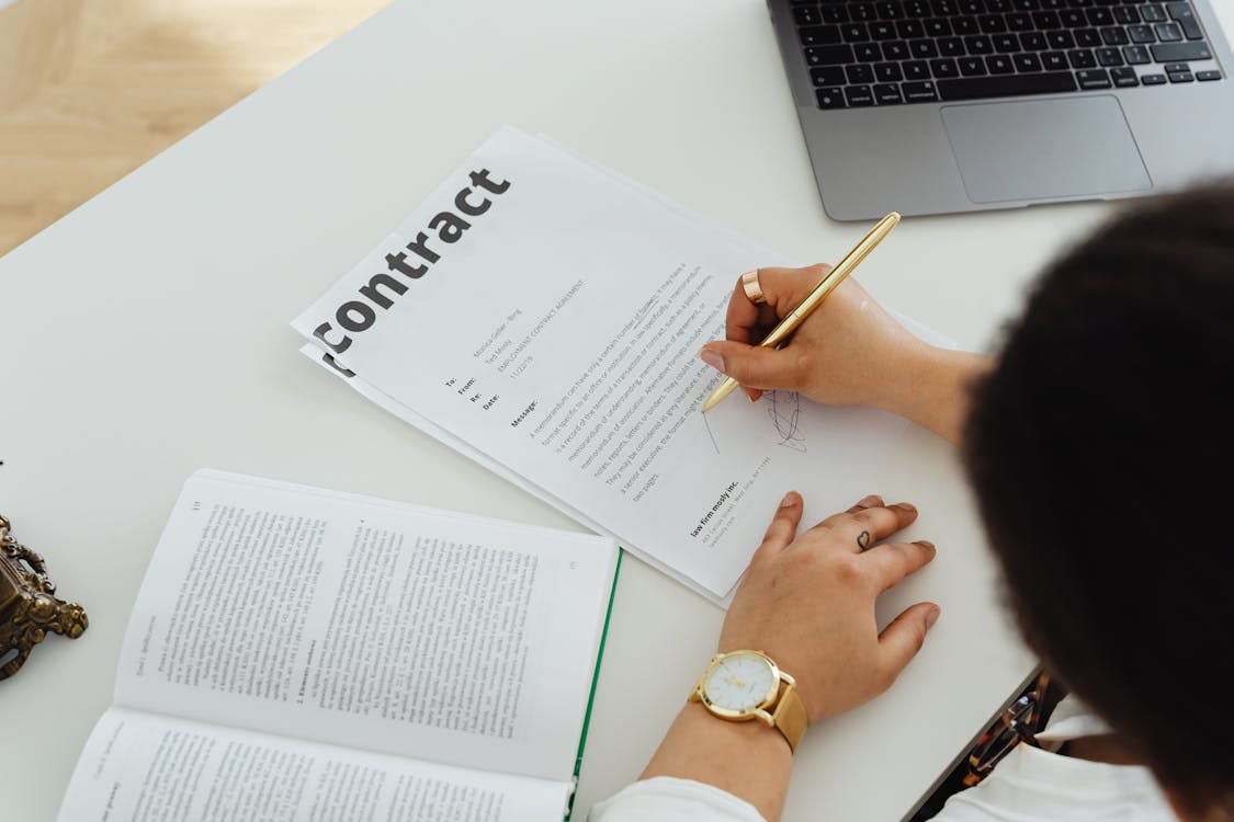 Person Signing a Contract · Free Stock Photo