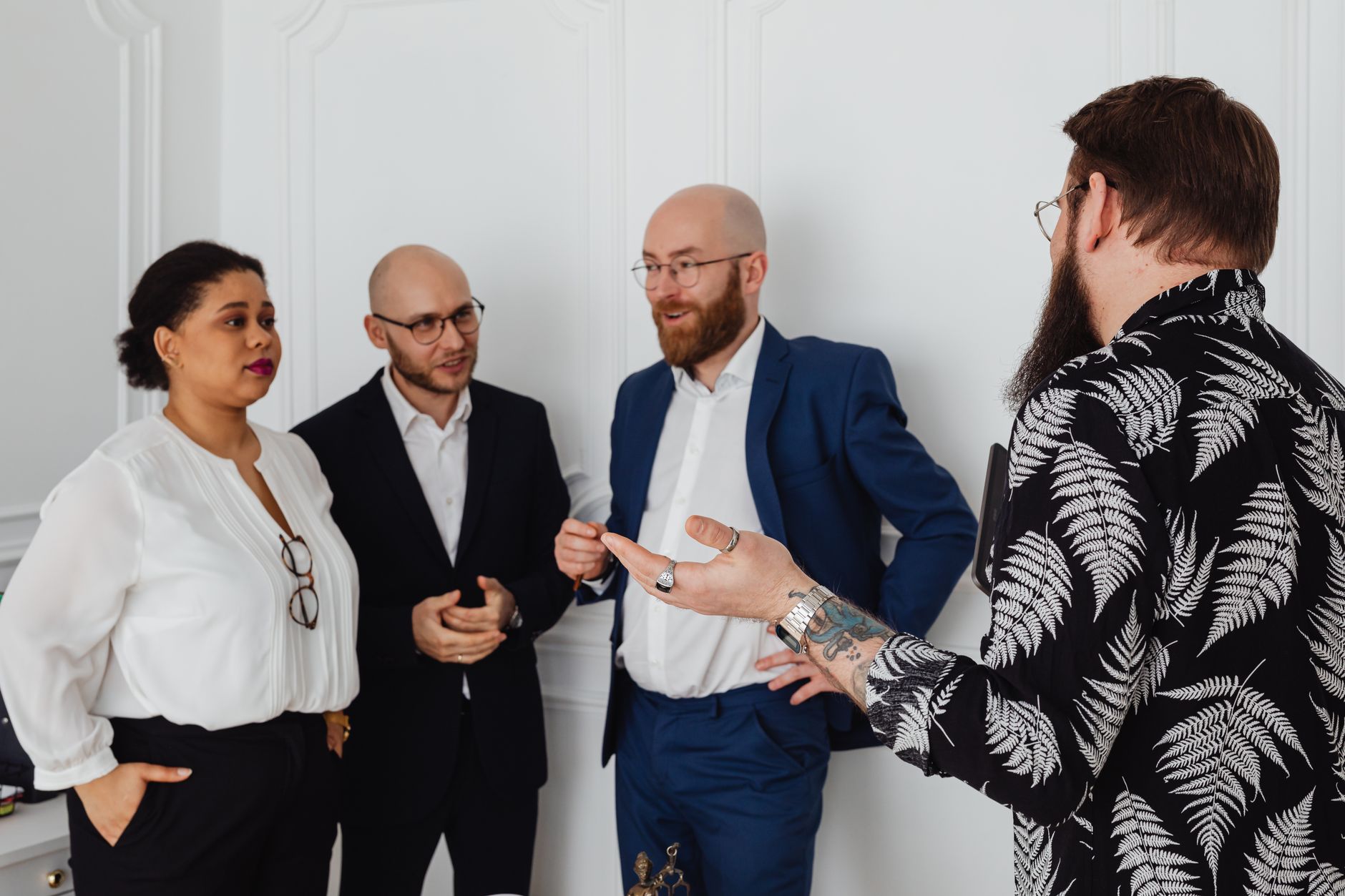 A diverse business team having an engaging conversation in a professional indoor setting.