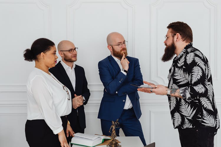 People In The Office Talking To A Client While Standing