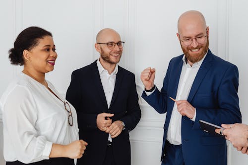 Men in Suit and a Woman in White Long Sleeves