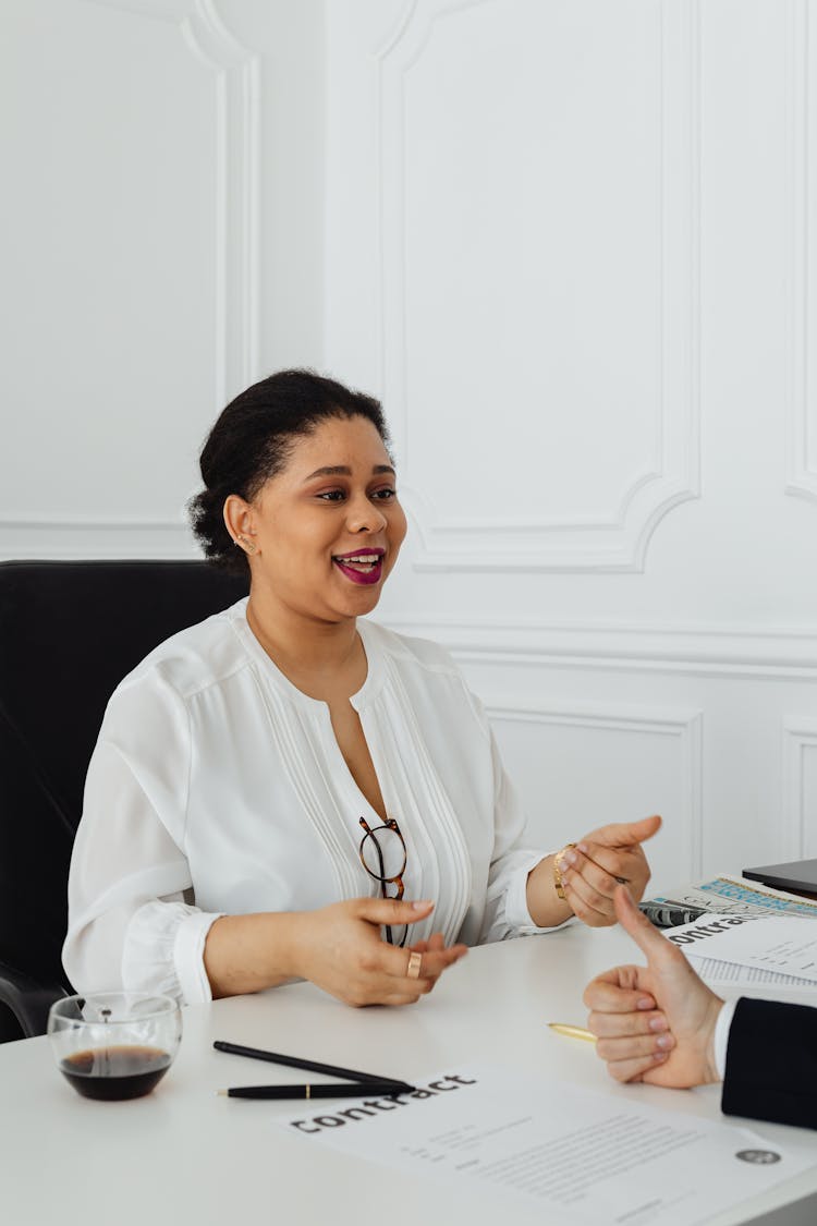 A Woman Receiving A Thumbs Up From A Business Associate