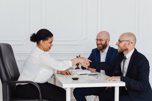 Free Businessmen in a Meeting with a Businesswoman Stock Photo