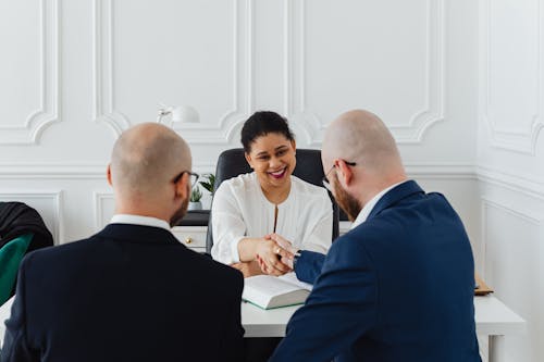 Free Businesspeople Shaking Hands for a Business Deal Stock Photo