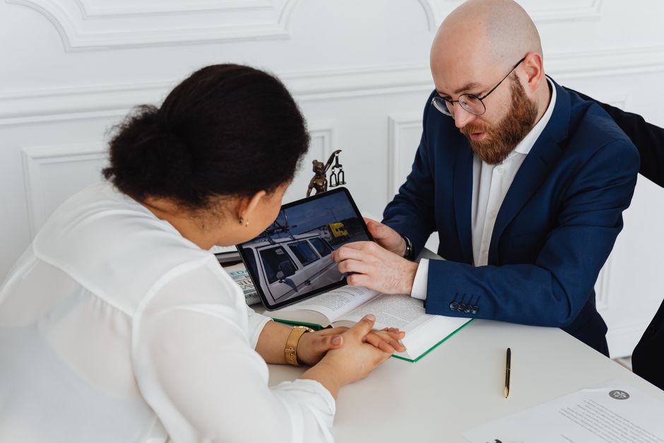 Man and woman in a professional office meeting discussing a project with digital presentations.
