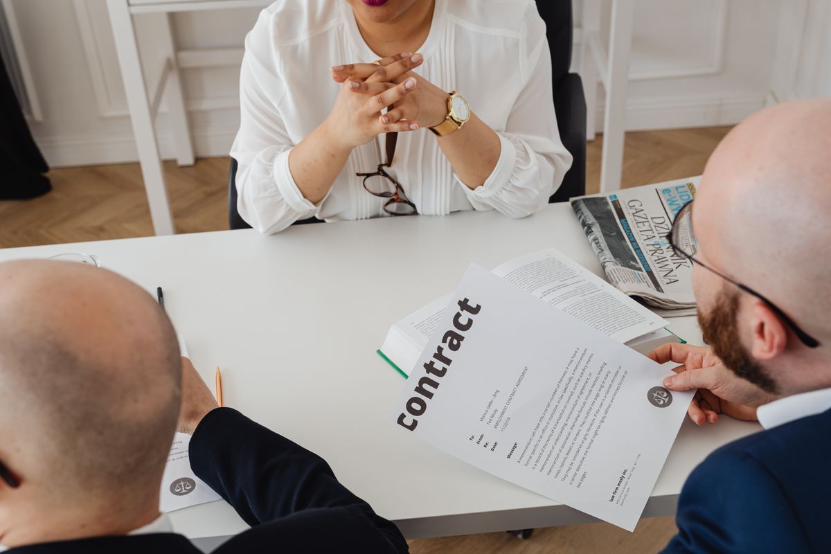 Professionals discussing a contract in a modern office