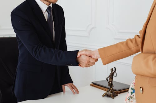 People in Corporate Attire Shaking Hands