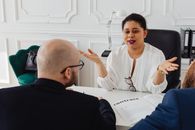 A Woman Talking at a Meeting