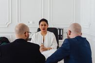 A Woman Talking at a Meeting
