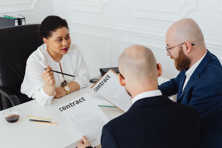 Woman Sitting While Explaining The Contracts