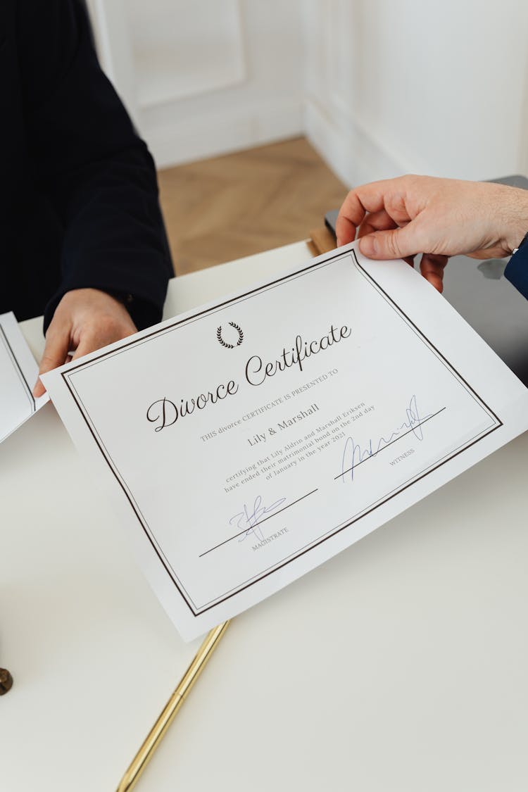 A Person Holding A Divorce Certificate