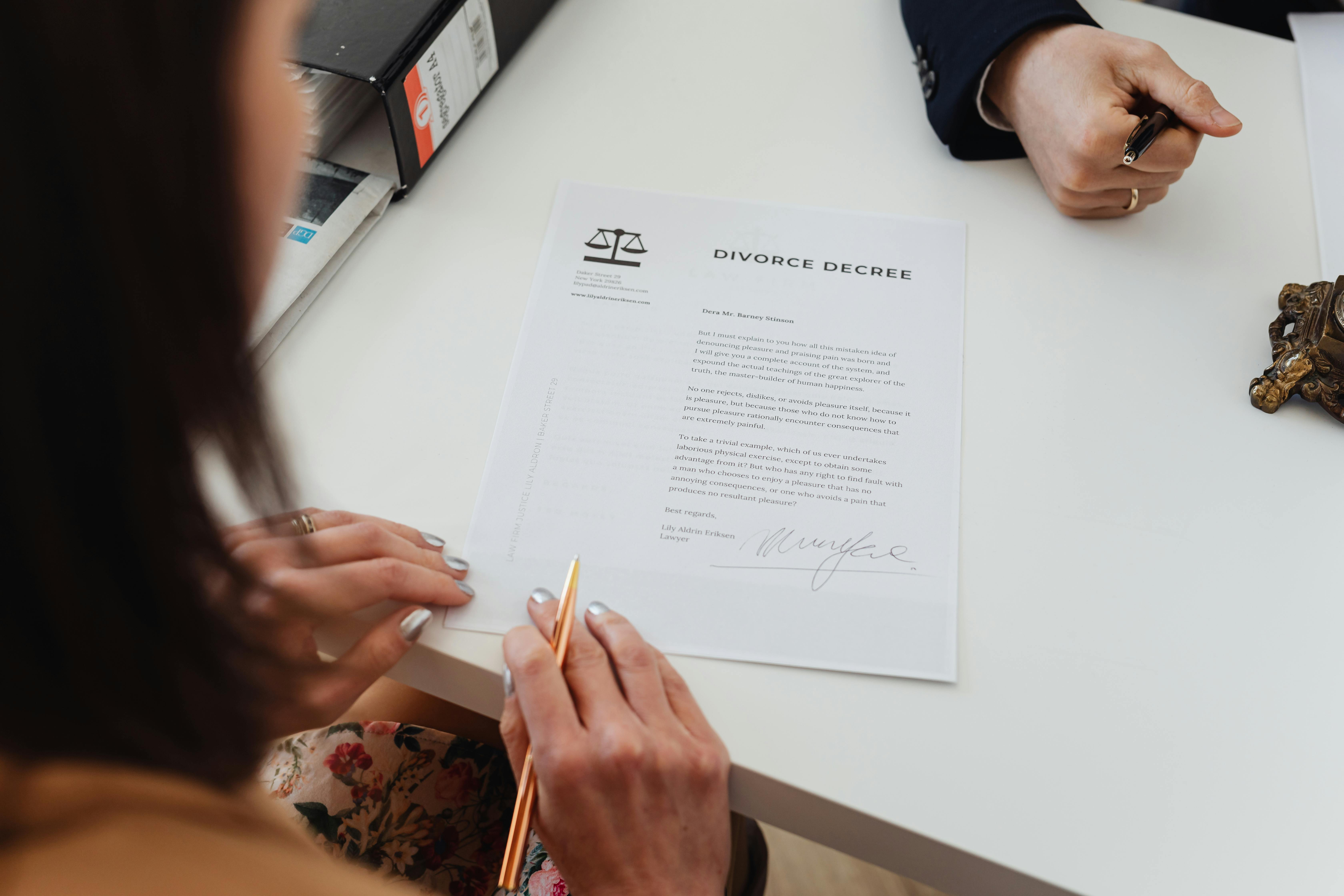 a woman reading a divorce decree paper