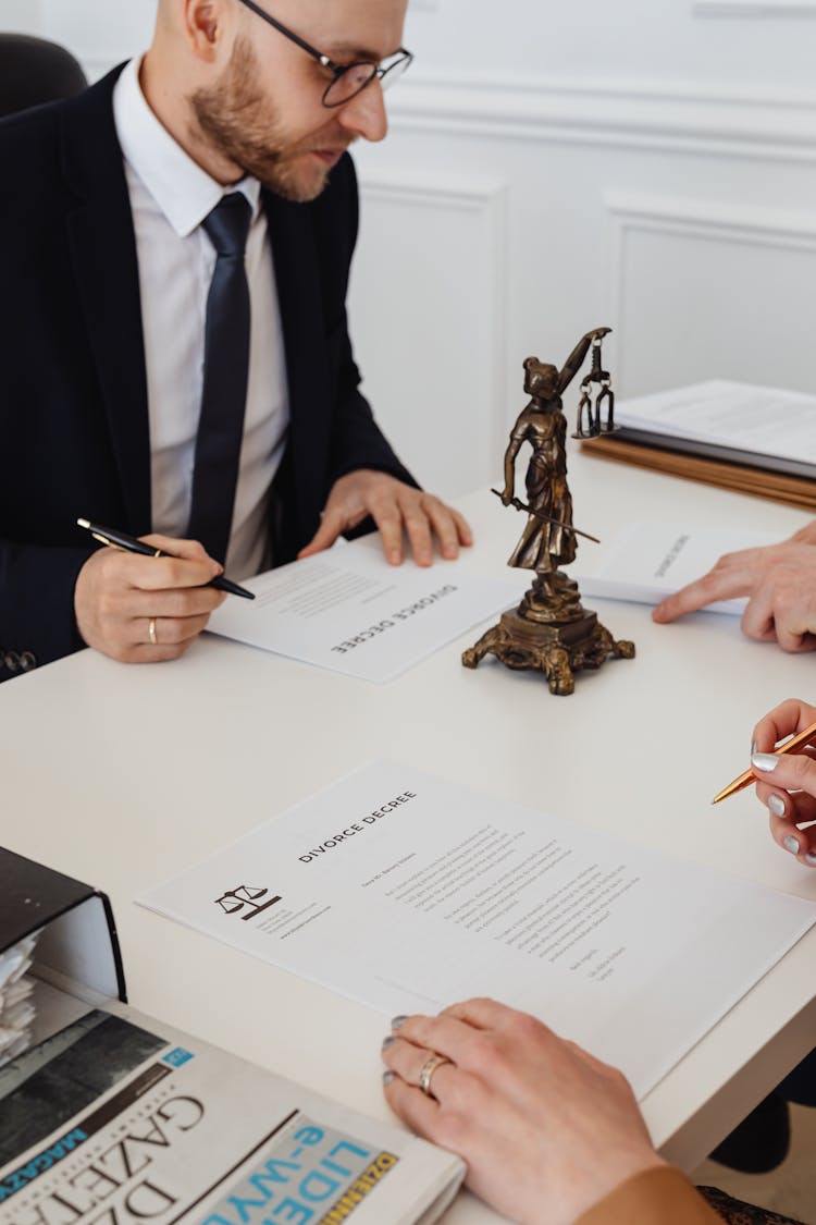 A Man Signing A Divorce Decree