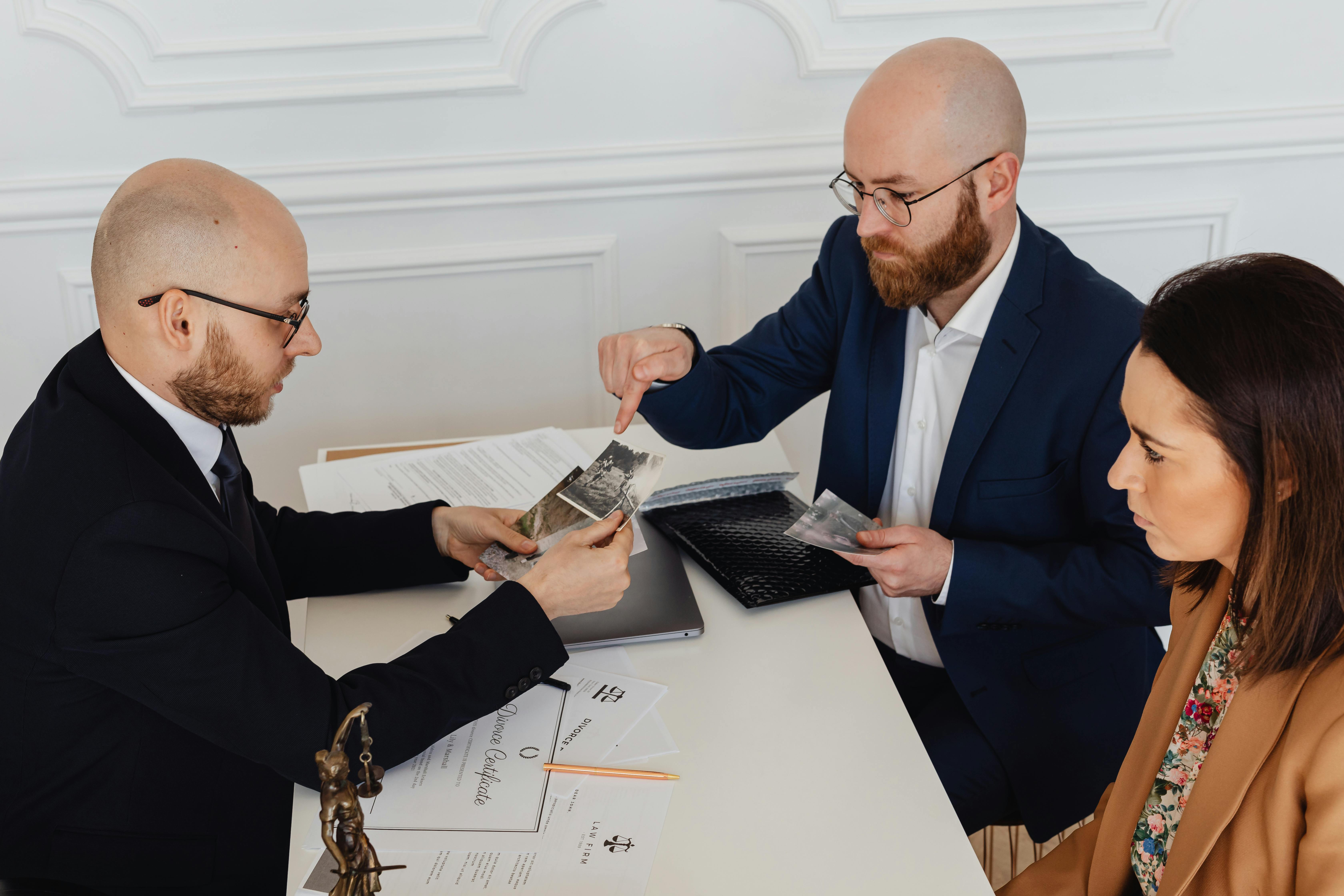 bearded man pointing his finger on the photos