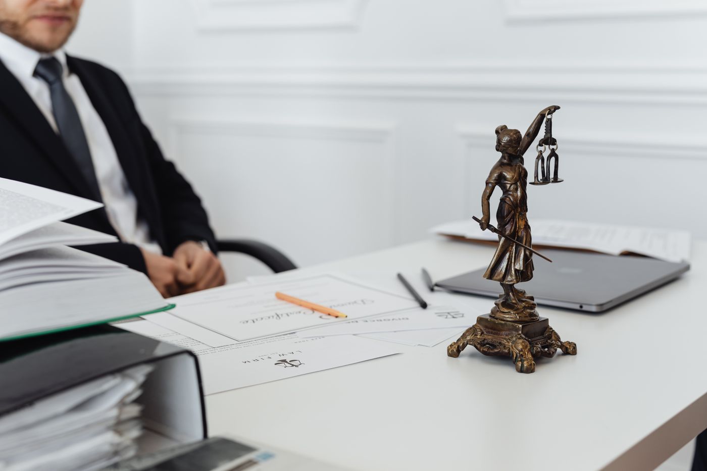 A legal workspace with documents and a laptop
