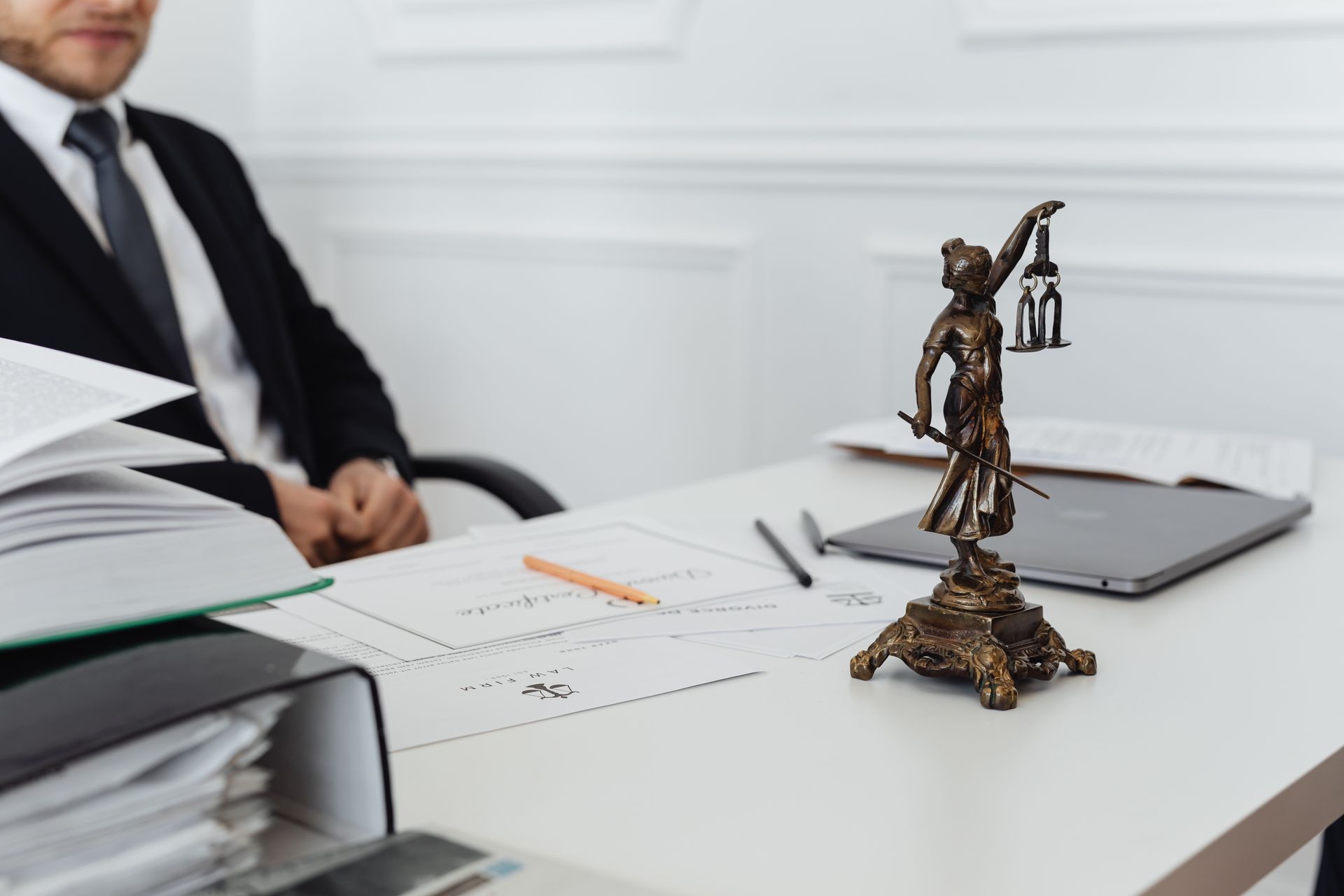 Courtroom gavel placed next to scales of justice