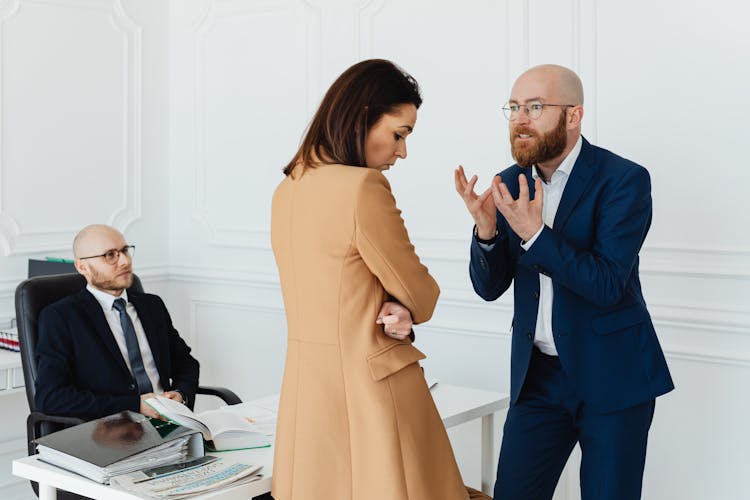 Angry Colleagues Arguing At Office