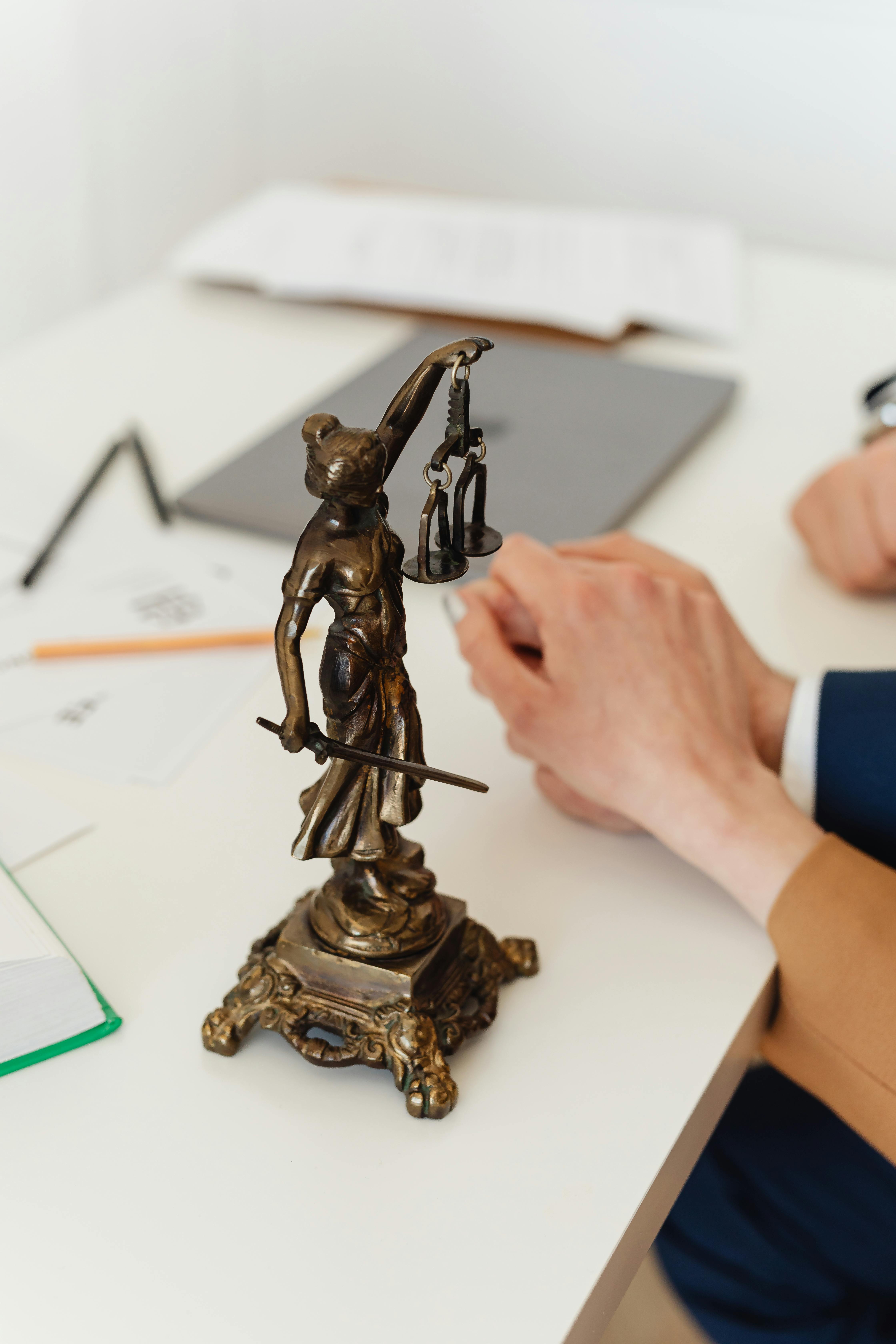 close up shot of a lady justice figurine on a white table