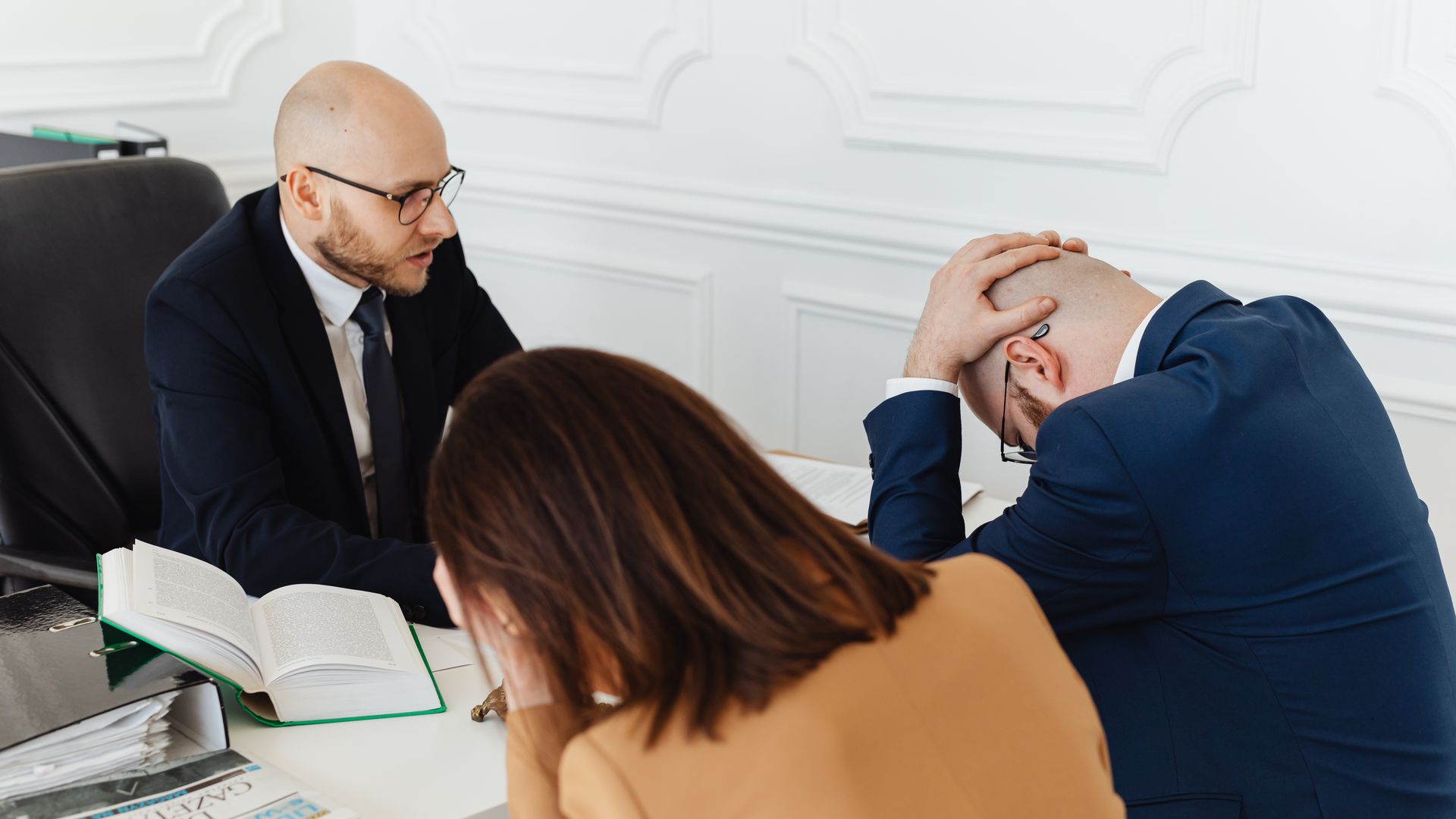 Is Modafinil Legal: Understanding the Legal Landscape Legal professionals engaged in a tense meeting at a law office with open documents on the desk — is modafinil legal