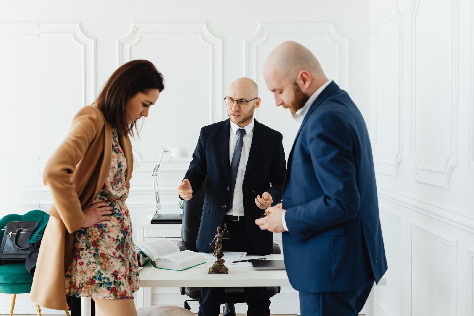 An attorney in conversation with clients in a meeting room