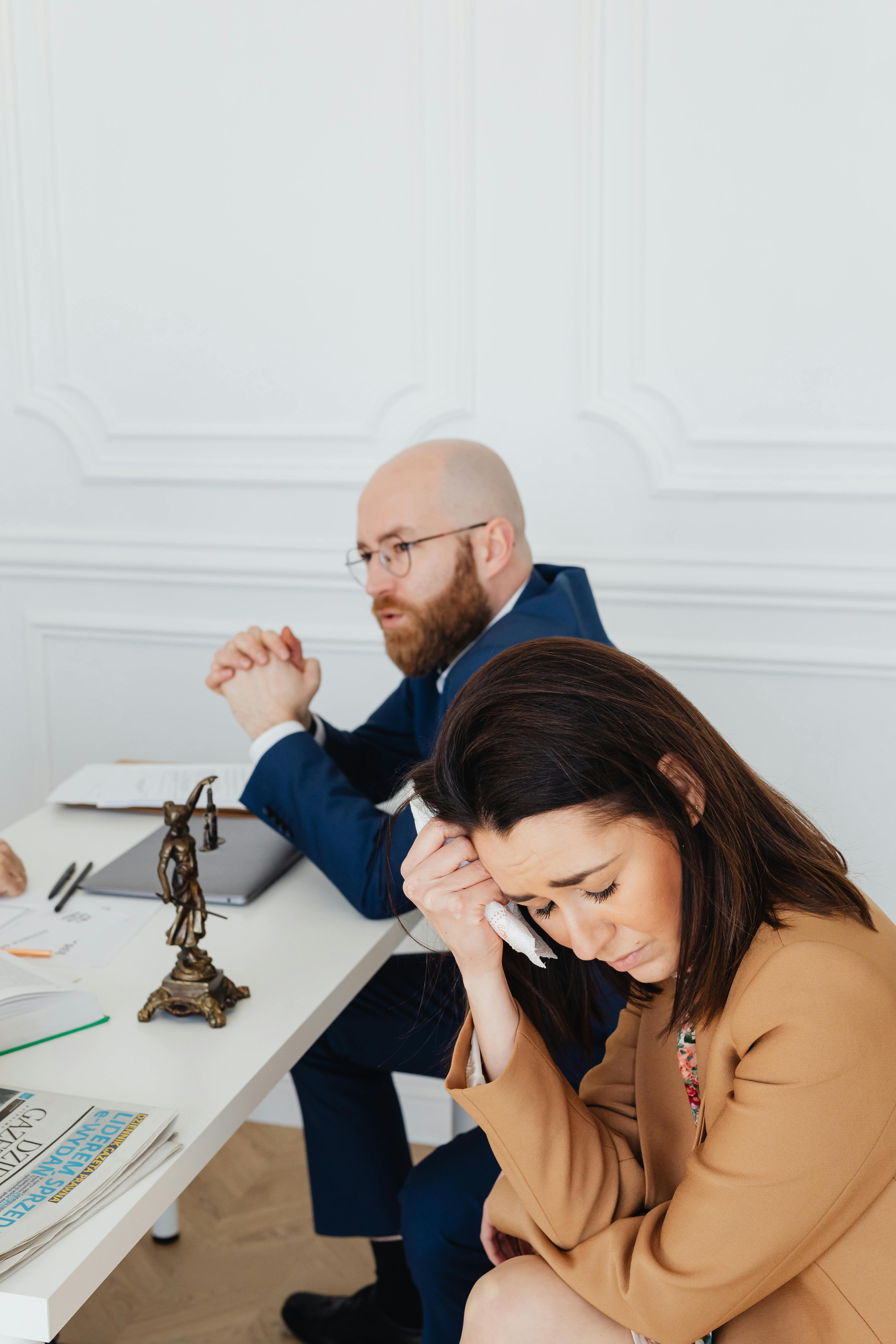 man sitting beside the woman crying