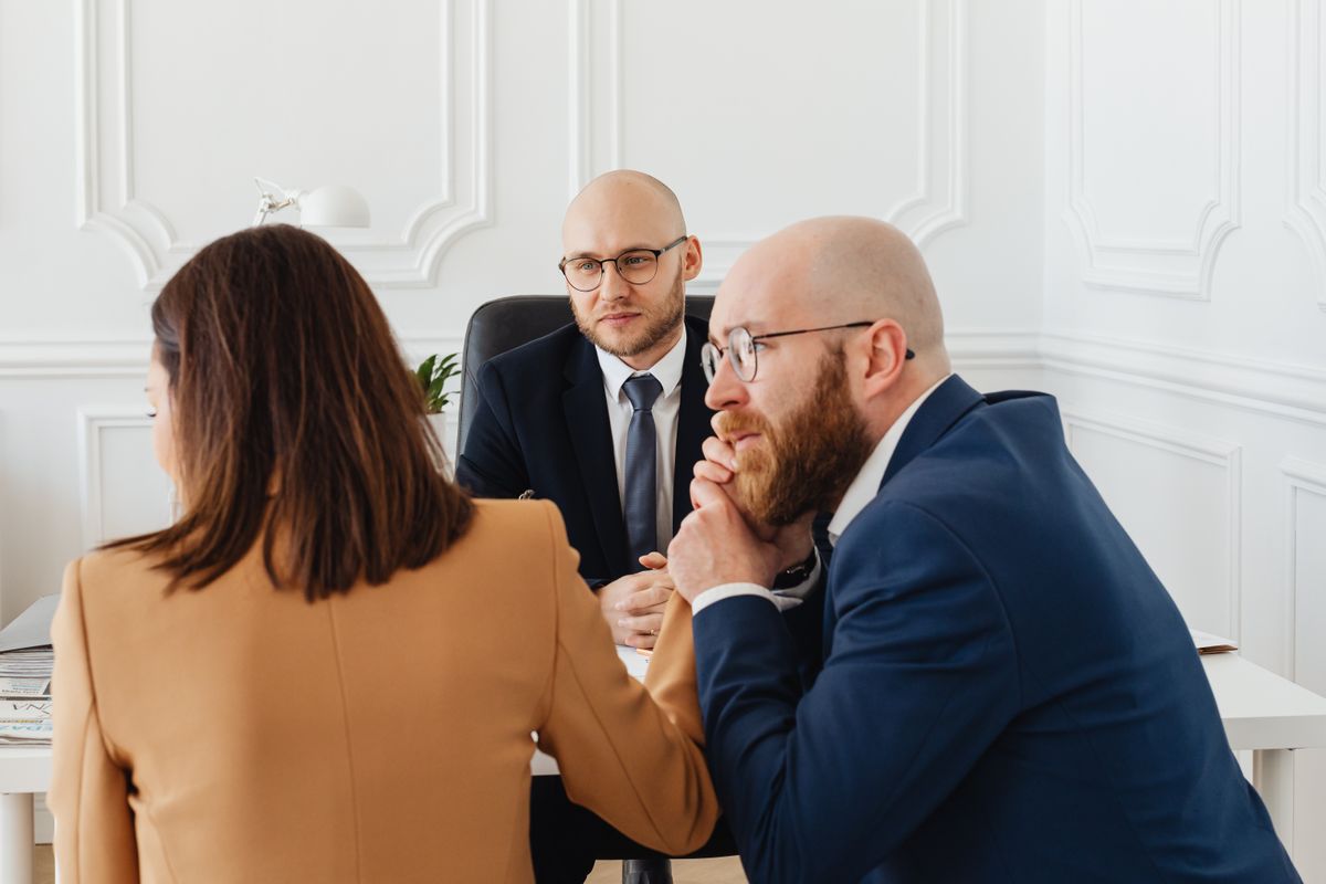 Lawyers consulting clients about an injury settlement