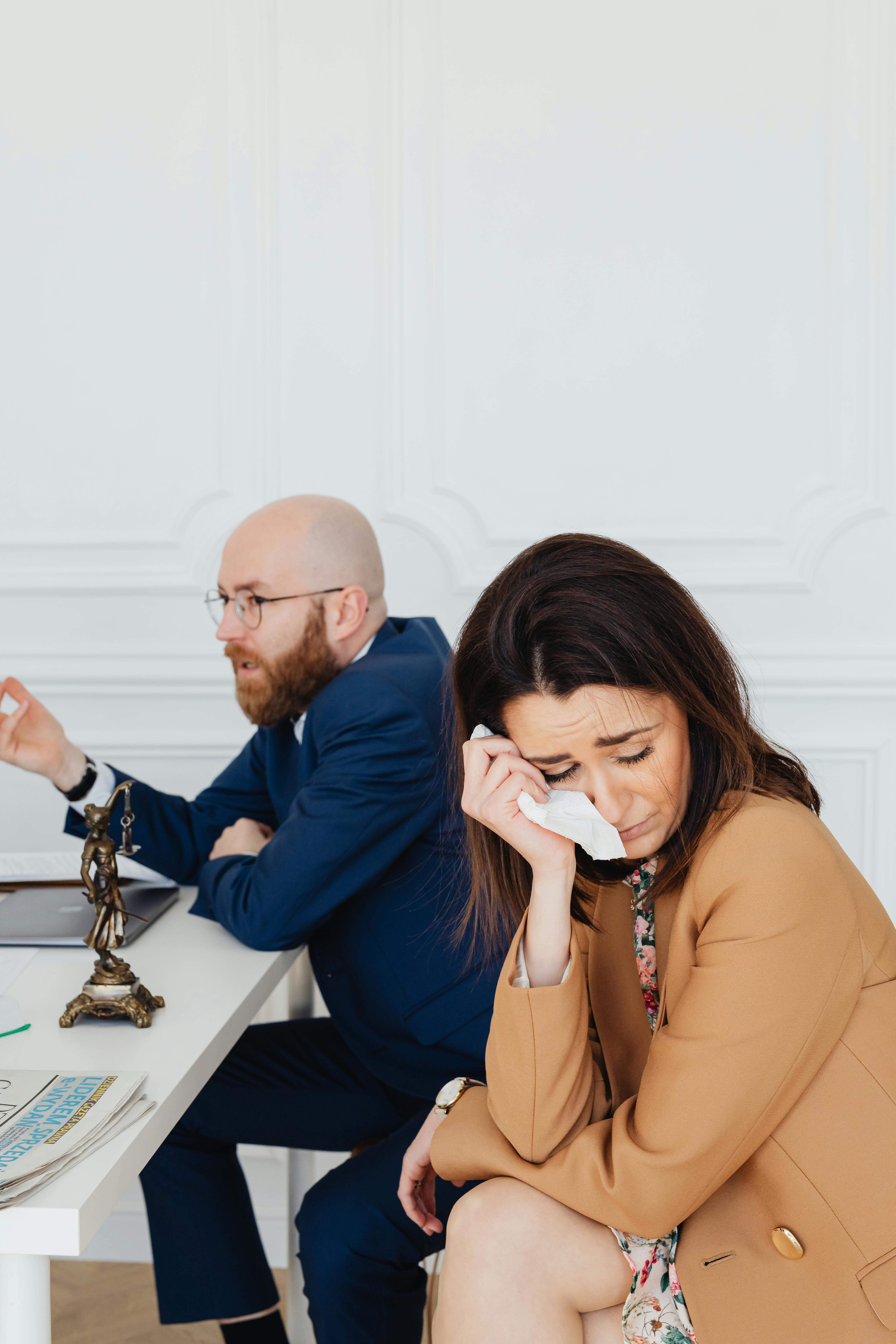 a couple in mediation hearing in a law office