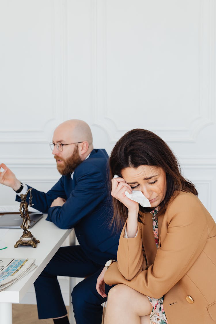 A Couple In Mediation Hearing In A Law Office