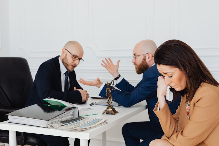 Sad Woman Sitting Beside The Bearded Man In Blue Blazer 