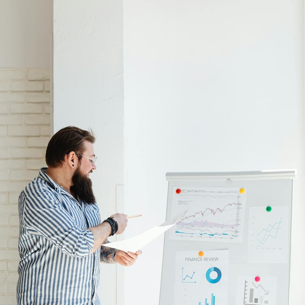 Man giving a presentation with charts and graphs.