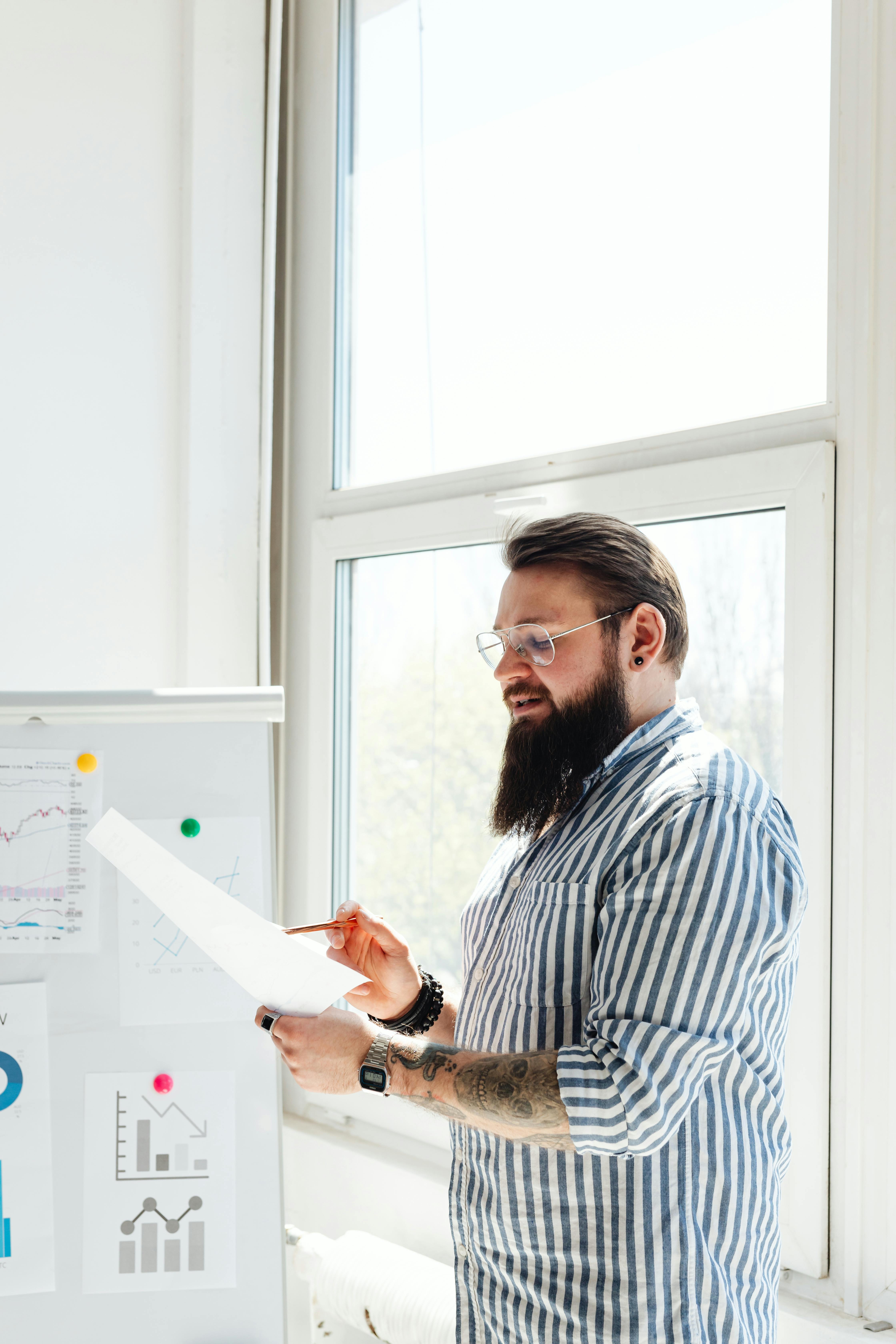 a bearded man discussing in front