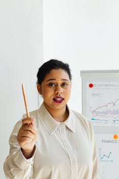 Confident professional woman presenting financial data on a clipboard indoors.