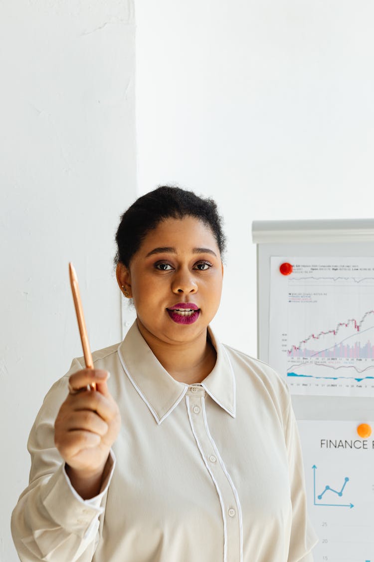 A Woman Talking While Holding A Pencil