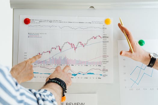 Two professionals analyze stock market graphs with a focus on finance and data trends.
