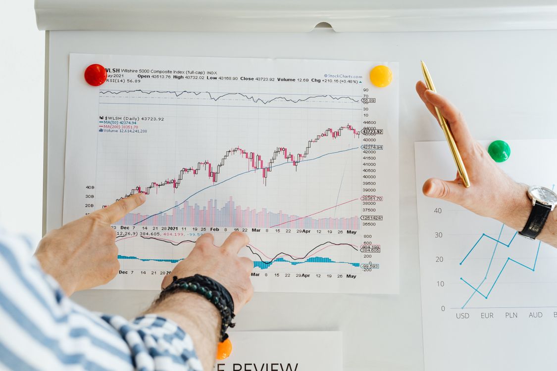 Free Two professionals analyze stock market graphs with a focus on finance and data trends. Stock Photo