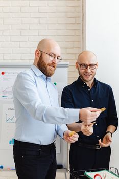 Two business professionals analyzing financial data in an office setting.