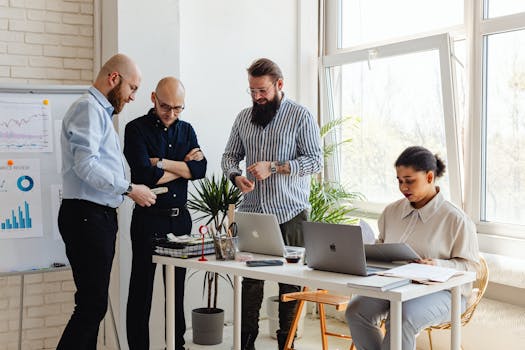 Business professionals collaborating on project in bright modern office space.