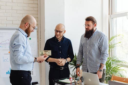 Three businessmen exchanging money in a modern office with financial charts.