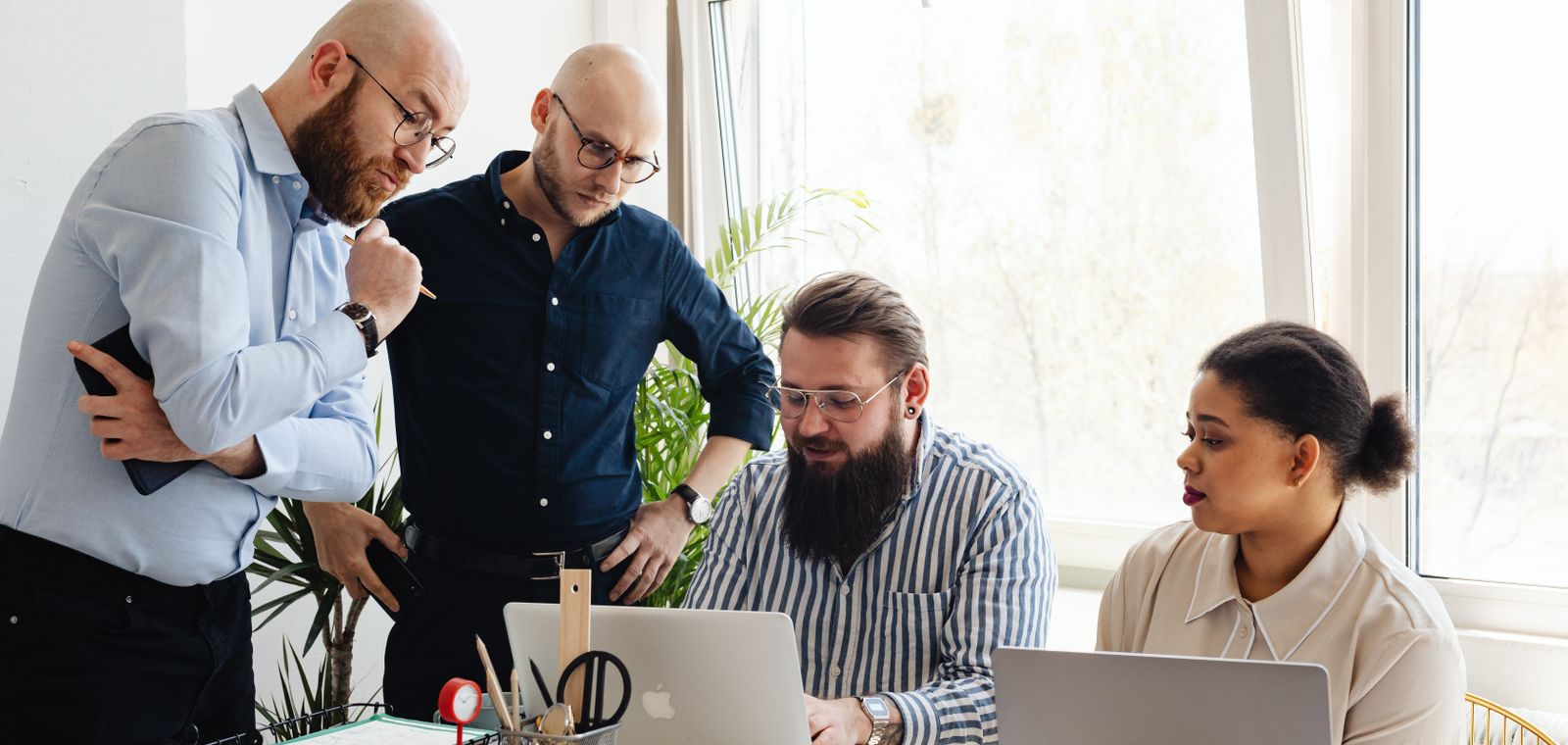 A leadership team reviewing the detail of a restructuring plan
