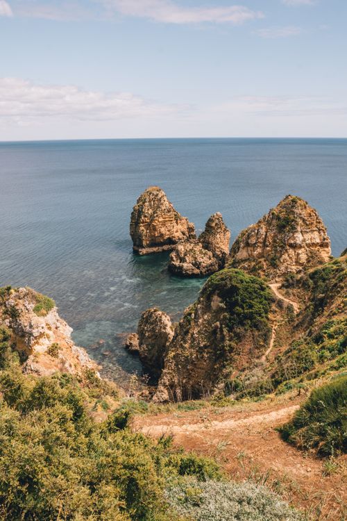 Free Breathtaking view of rocky cliffs and ocean in Faro, Portugal, capturing natural beauty. Stock Photo