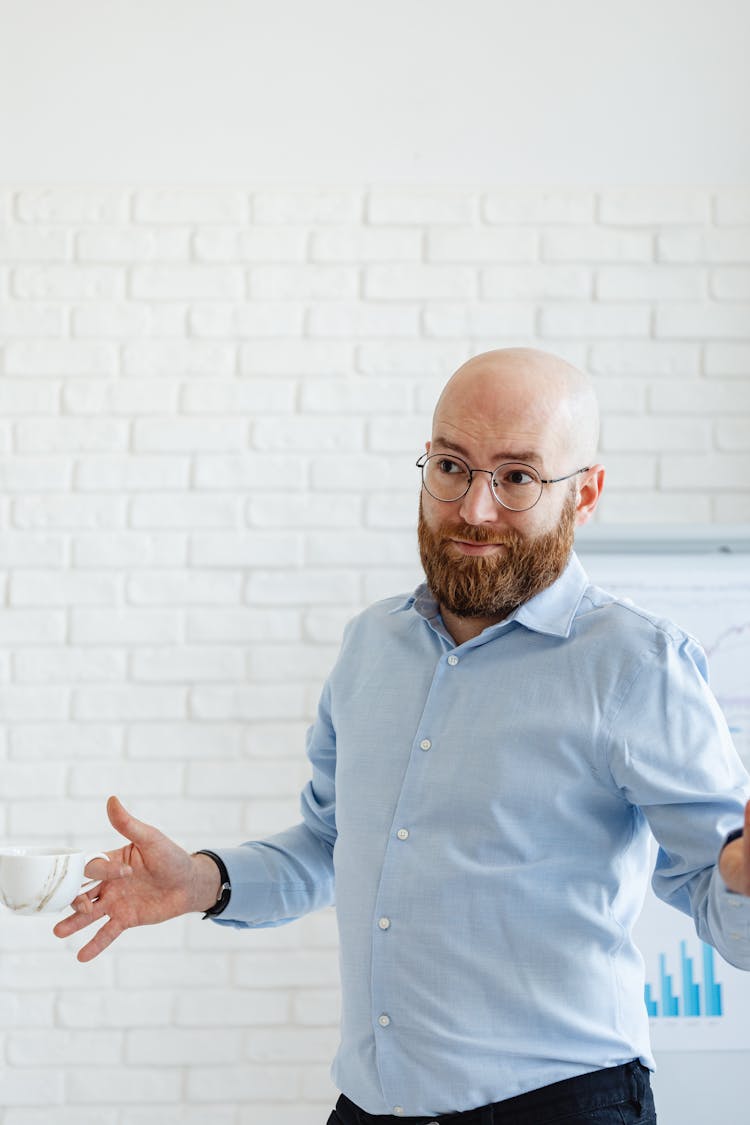 Man In Blue Shirt Gesturing